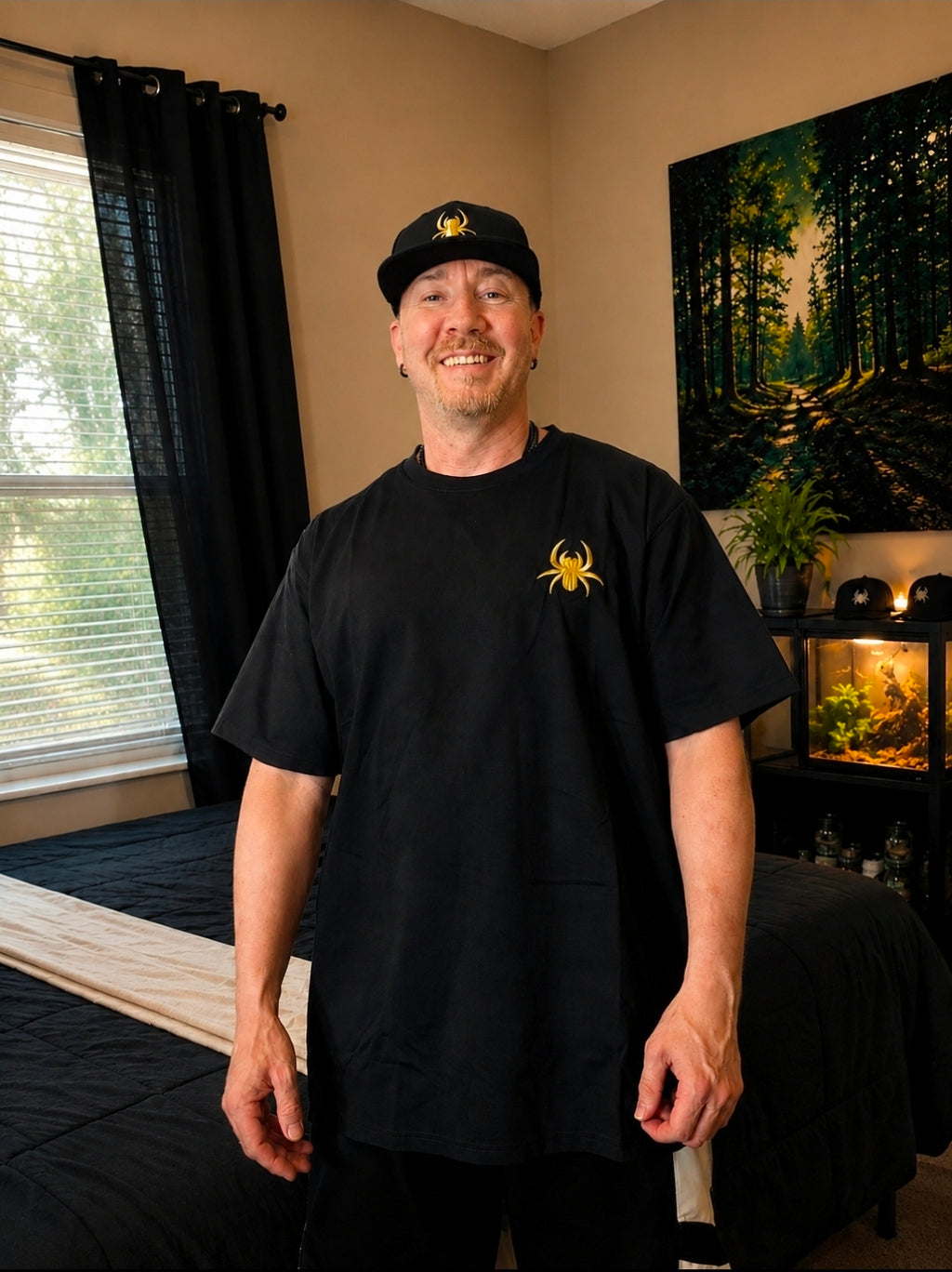 Black SilkNook T-shirt featuring a gold spider logo on the front, displayed