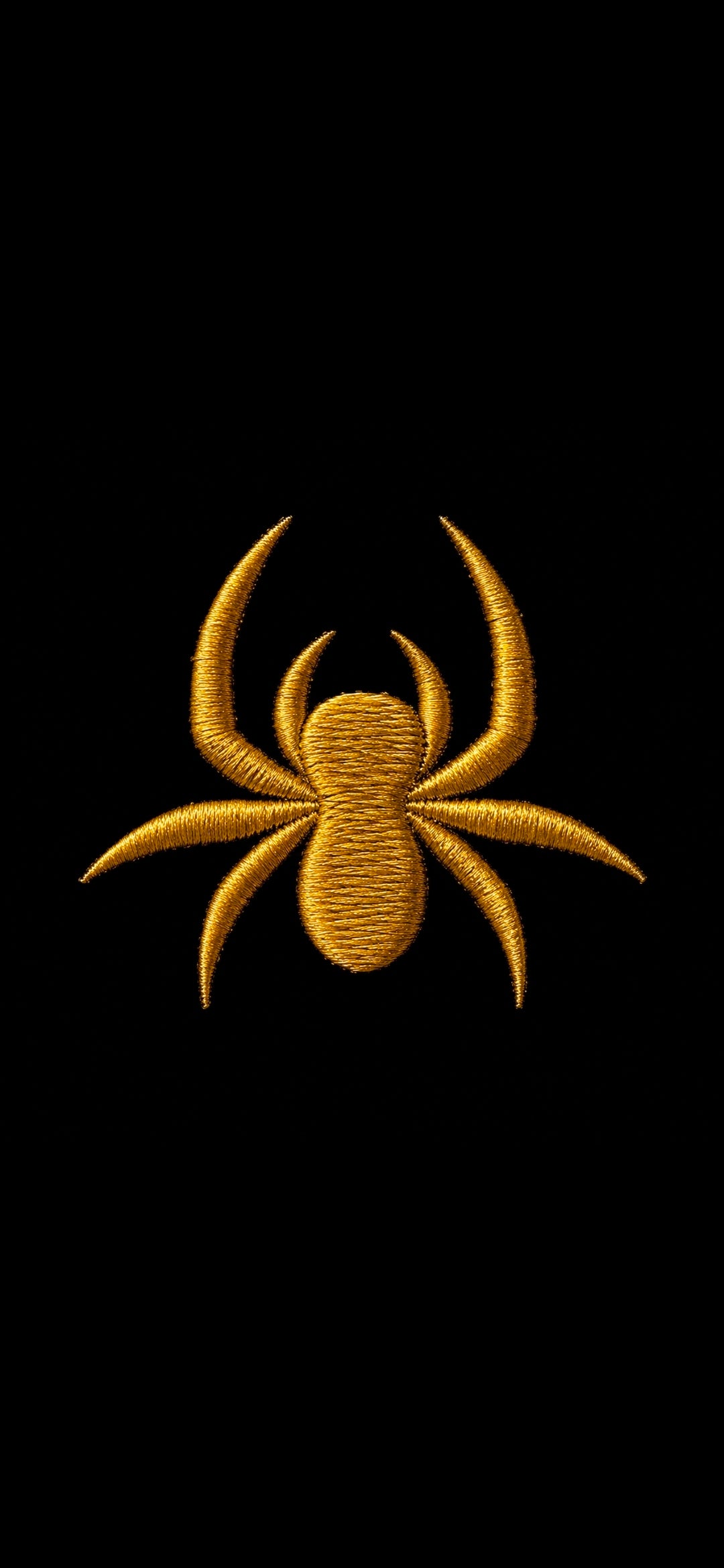 Close-up of the SilkNook gold embroidered jumping spider logo on black fabric, highlighting the detailed gold stitching.